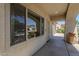 Inviting entryway featuring a covered porch, large windows, and desert landscaping at 16186 W Port Royale Ln, Surprise, AZ 85379