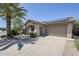 Inviting single-story home featuring a covered porch, desert landscaping, and solar panels at 16186 W Port Royale Ln, Surprise, AZ 85379