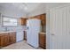 Well-lit kitchen features wood cabinets, tile floors, stainless steel appliances, and ample counter space at 16186 W Port Royale Ln, Surprise, AZ 85379