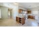 View of a kitchen with tile floor and a decorative central island with storage for wine at 16186 W Port Royale Ln, Surprise, AZ 85379