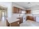 Well-maintained kitchen with tile flooring, wooden cabinets, and white appliances at 16186 W Port Royale Ln, Surprise, AZ 85379
