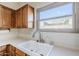 Kitchen sink beneath a window providing natural light, features stainless steel faucet at 16186 W Port Royale Ln, Surprise, AZ 85379
