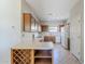 Open kitchen area with tiled flooring, wooden cabinets, and stainless steel appliances at 16186 W Port Royale Ln, Surprise, AZ 85379