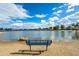 Bench near the water on the lake, inviting residents to relax and enjoy the views at 16186 W Port Royale Ln, Surprise, AZ 85379