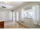 Bright living room showcasing tile floors, neutral paint and large windows allowing natural light, creating a welcoming atmosphere at 16186 W Port Royale Ln, Surprise, AZ 85379