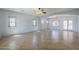 Spacious living room with tile flooring, arched doorways, and plenty of natural light at 16186 W Port Royale Ln, Surprise, AZ 85379