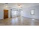Open living room featuring tile flooring, natural light, and a welcoming front door at 16186 W Port Royale Ln, Surprise, AZ 85379