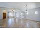Large open floor plan with tile floors, multiple windows, and lots of natural light at 16186 W Port Royale Ln, Surprise, AZ 85379