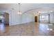 Open concept living and dining area with tile floors, and easy access to the kitchen at 16186 W Port Royale Ln, Surprise, AZ 85379