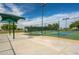 A green canopy provides shade near a pickleball court, creating an ideal area for players to rest and socialize at 16186 W Port Royale Ln, Surprise, AZ 85379