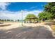 A lakeside gazebo with picnic tables invites community gatherings amid lush greenery and serene waters at 16186 W Port Royale Ln, Surprise, AZ 85379