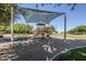 Covered playground with slides and play equipment in a Gathering-friendly community park at 16186 W Port Royale Ln, Surprise, AZ 85379