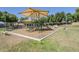 Community playground with various play structures and benches, perfect for outdoor recreation at 16186 W Port Royale Ln, Surprise, AZ 85379