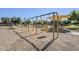 A fun playground featuring swings and play structures under shaded canopies in a community park at 16186 W Port Royale Ln, Surprise, AZ 85379
