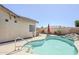 Backyard featuring a private pool with surrounding patio and lush desert landscaping, perfect for summer at 16186 W Port Royale Ln, Surprise, AZ 85379