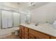 Bathroom with wood cabinets, white countertops, and a shower-tub combination at 16526 W Desert Ln, Surprise, AZ 85388