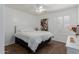 Simple bedroom features neutral tones, white shuttered window, and motorcycle art print at 16526 W Desert Ln, Surprise, AZ 85388