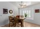 Cozy dining area featuring a ceiling fan, bright window, and charming decor at 16526 W Desert Ln, Surprise, AZ 85388
