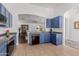 Modern kitchen with open design, sleek countertops, blue cabinets, and stainless steel appliances at 16526 W Desert Ln, Surprise, AZ 85388