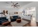 Bright living room with open floor plan, modern furnishings, and access to dining area at 16526 W Desert Ln, Surprise, AZ 85388