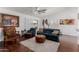 Cozy living room features plush seating, ceiling fan, and sliding doors to outdoor space at 16526 W Desert Ln, Surprise, AZ 85388