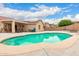 Sparkling backyard pool, solar panels, and a covered patio, perfect for outdoor living at 16526 W Desert Ln, Surprise, AZ 85388