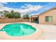 Inviting backyard pool with a cleaner, covered patio, and a well-maintained fence at 16526 W Desert Ln, Surprise, AZ 85388