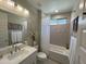 Updated bathroom with new fixtures, white cabinets, and tub with shower at 16822 W Catalina Dr, Goodyear, AZ 85395