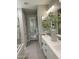 Bright bathroom with double sinks, sleek white cabinets, and walk-in shower at 16822 W Catalina Dr, Goodyear, AZ 85395