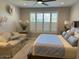Spacious primary bedroom boasting a sitting area, plantation shutters, and soft decor at 16822 W Catalina Dr, Goodyear, AZ 85395