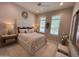 Relaxing bedroom featuring plush carpet and plantation shutters at 16822 W Catalina Dr, Goodyear, AZ 85395