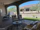 Inviting covered patio with outdoor seating, a built-in grill, and well-maintained landscaping at 16822 W Catalina Dr, Goodyear, AZ 85395