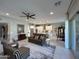 Bright, open living room features modern furniture and decor flowing into kitchen and dining areas at 16822 W Catalina Dr, Goodyear, AZ 85395