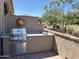Beautiful outdoor kitchen with stainless steel BBQ, counter space, and an artistic decor at 16822 W Catalina Dr, Goodyear, AZ 85395