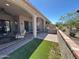 Inviting patio with built-in grill, comfortable seating, and a view of the surrounding landscape at 16822 W Catalina Dr, Goodyear, AZ 85395