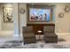 Comfortable seating area with modern decor and a large screen TV above a built-in cabinet at 16822 W Catalina Dr, Goodyear, AZ 85395