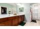 This bathroom features a double sink vanity, and a private door to the backyard at 17717 W Mandalay Ln, Surprise, AZ 85388