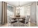 Bright dining room featuring a stylish chandelier and direct access to outdoor living space at 17717 W Mandalay Ln, Surprise, AZ 85388