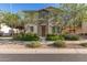 Charming two-story home featuring stone accents, a welcoming front door, and well-maintained landscaping at 17717 W Mandalay Ln, Surprise, AZ 85388