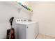 Functional laundry room featuring a washer, dryer, and overhead storage shelf at 17717 W Mandalay Ln, Surprise, AZ 85388