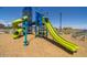 Colorful community playground with slides, climbing structures, and a soft surface for safe outdoor fun at 17836 W Pasadena Ave, Litchfield Park, AZ 85340