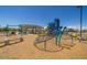 Community playground featuring a variety of play structures, climbing nets, and slides for Gathering fun at 17836 W Pasadena Ave, Litchfield Park, AZ 85340