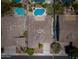 Aerial view showing backyard pools, spas, lush landscaping, and neighborhood rooftops at 1904 E Grand Canyon Dr, Chandler, AZ 85249