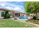 A well-maintained backyard, a sparkling pool, desert landscaping, and a covered patio enhance this outdoor living space at 1904 E Grand Canyon Dr, Chandler, AZ 85249