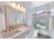 Bathroom with double sinks, a large mirror, and a shower with glass doors at 1904 E Grand Canyon Dr, Chandler, AZ 85249