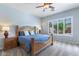 This cozy bedroom offers natural light, a ceiling fan, and a comfortable bed at 1904 E Grand Canyon Dr, Chandler, AZ 85249