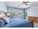 This bedroom offers backyard views, pool access and a stylish ceiling fan at 1904 E Grand Canyon Dr, Chandler, AZ 85249