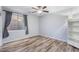 Relaxing bedroom with wood-look floors, ceiling fan, window, and closet, creating a comfortable space at 1904 E Grand Canyon Dr, Chandler, AZ 85249