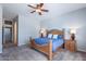 This bedroom features carpeted floors, side tables, lamps and ceiling fan at 1904 E Grand Canyon Dr, Chandler, AZ 85249