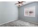 Bedroom with a ceiling fan and shuttered windows for natural light at 1904 E Grand Canyon Dr, Chandler, AZ 85249